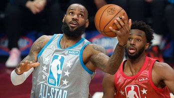 LeBron James seen trying to keep it together during Macy Gray's national anthem performance