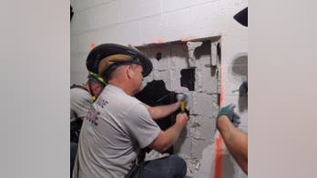 Florida fire rescue crews break through wall to rescue pair trapped in elevator on 37th floor