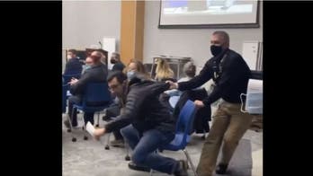 Maskless New York parent booted from school board meeting days after school officials posed maskless