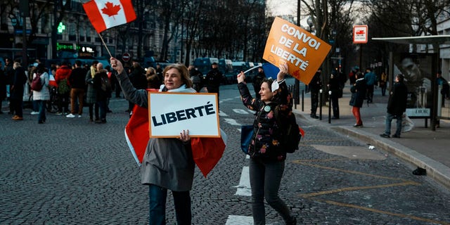 Protesters hold placards at a demonstration in Paris. 