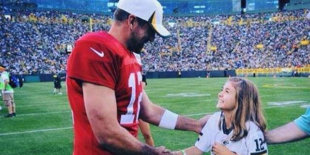 An 11-year-old Franki Moscato, at right, shakes hands with Aaron Rodgers of the Packers in 2013, after she sang the national anthem in front of a packed stadium at Lambeau Field in Green Bay, Wisconsin.
