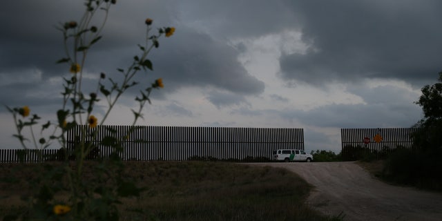 A border patrol agent guards a gap in the Mexico-U.S. border fence in the Rio Grande Valley sector, near McAllen, Texas, U.S., April 5, 2018.