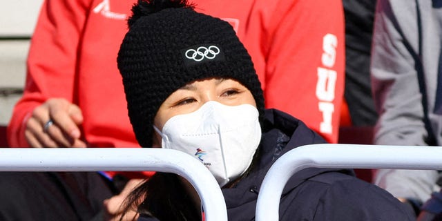 China's Peng Shuai, wearing a face mask, watches an event.