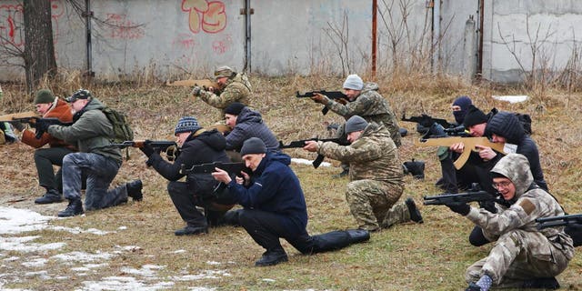 People take part in a military exercise for civilians conducted by veterans of the Ukrainian National Guard Azov battalion in Kharkiv, Ukraine February 19, 2022. REUTERS/Vyacheslav Madiyevskyy