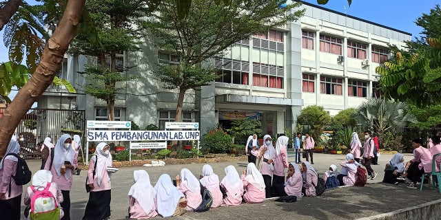 Primary school students evacuate from a school building after a 6.2 magnitude earthquake in Sumatra Island, Indonesia, on February 25, 2022
