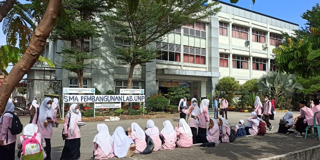 Siswa sekolah dasar mengevakuasi gedung sekolah setelah gempa berkekuatan 6,2 melanda pulau Sumatera, Indonesia, 25 Februari 2022.