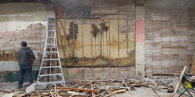 Nick Timm, U.S. Air Force veteran and managing partner of Solutions Weed and Pest Control, worked with his team to repair the old building he purchased with his wife. They eventually discovered two murals were hidden behind plaster walls.