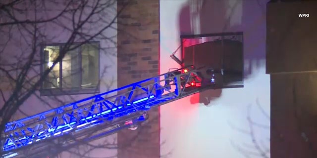 A fire department ladder is seen extended to the third floor during a fire at Genesis Healthcare's Respiratory and Rehabilitation Center in Coventry, Rhode Island, Feb. 3, 2021.