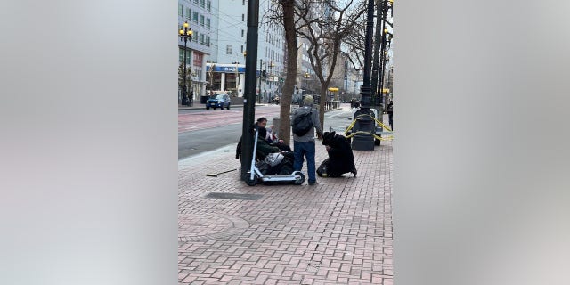 Homeless people sit in San Francisco's Tenderloin District 