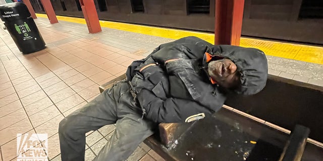 Man sleeping in subway station. 