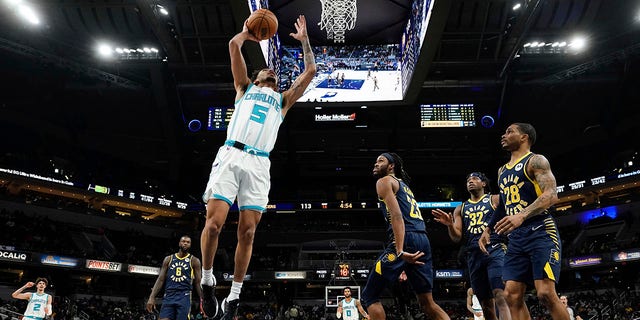 Charlotte Hornets guard James Bouknight dunks in front of Indiana Pacers forward Isaiah Jackson in Indianapolis on Jan. 26, 2022.
