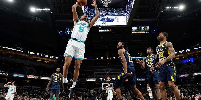 Charlotte Hornets guard James Bouknight dunks in front of Indiana Pacers forward Isaiah Jackson in Indianapolis on Jan. 26, 2022.