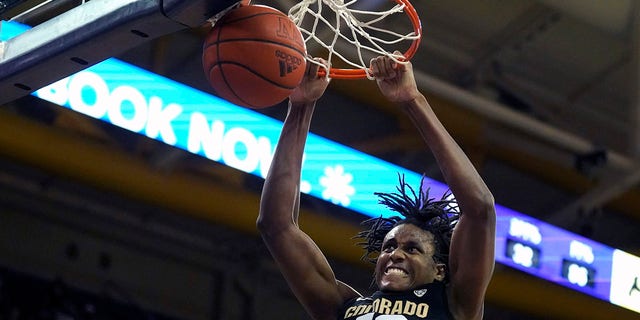 Colorado forward Jabari Walker dunks against Washington during the second half of an NCAA college basketball game, Thursday, Jan. 27, 2022, in Seattle. Washington won 60-58.