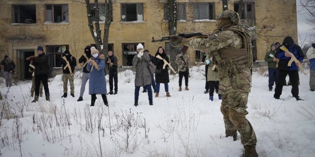 Local residents train close to Kyiv, Ukraine, Sunday, Jan. 30, 2022. Russia's foreign minister claims that NATO wants to pull Ukraine into the alliance, amid escalating tensions over NATO expansion and fears that Russia is preparing to invade Ukraine. 