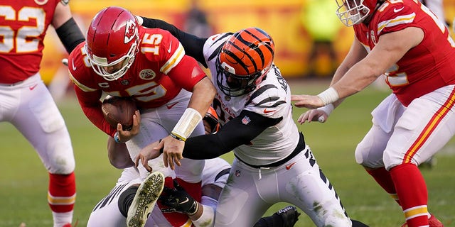 Kansas City Chiefs quarterback Patrick Mahomes (15) is sacked by Cincinnati Bengals defensive end Trey Hendrickson, right, during the second half of the AFC championship NFL football game, Sunday, Jan.  30, 2022, in Kansas City, Mo.