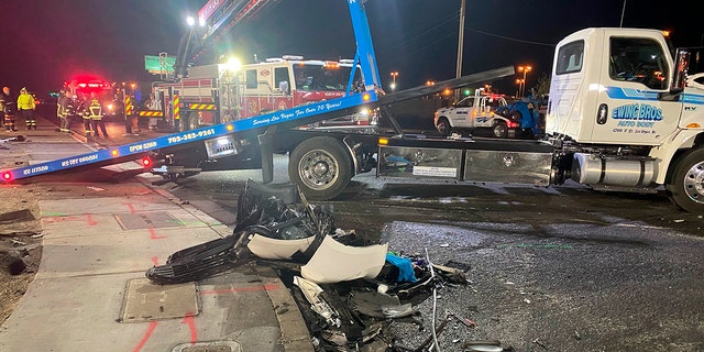 Authorities get set to tow a vehicle involved a six-car crash at the scene of a fatal crash on West Cheyenne Avenue in North Las Vegas, Sunday, Jan. 30, 2022.
