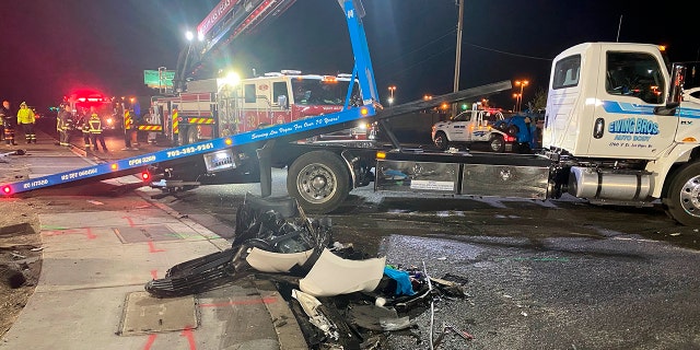 Authorities get set to tow a vehicle involved a six-car crash at the scene of a fatal crash on West Cheyenne Avenue in North Las Vegas, Sunday, Jan. 30, 2022.