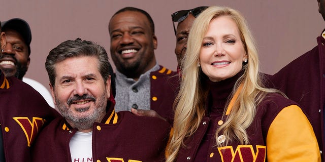 Dan and Tanya Snyder, co-owner and co-CEOs of the Washington Commanders, pose for photos after unveiling their NFL football team's new identity, Wednesday, Feb. 2, 2022, in Landover, Md.