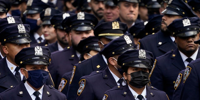 New York Police officers gather outside St. Patrick's Cathedral for Officer Wilbert Mora's funeral, Wednesday, Feb. 2, 2022, in New York.