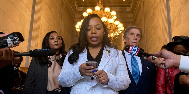 Democratic state Sen. Katrina Robinson looks at her phone in Nashville, Tennessee, at the Capitol on Wednesday, Feb. 2, 2022. The Republican-led Tennessee Senate voted Wednesday to remove Robinson from office because of her recent wire fraud conviction, the first time the chamber has removed a senator since at least the Civil War. 
