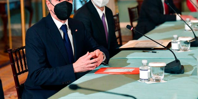 Secretary of State Antony Blinken, left, speaks to the media before meeting with Polish Foreign Minister Zbigniew Rau, not shown, at the State Dept., Friday, Feb. 4, 2022 in Washington. 