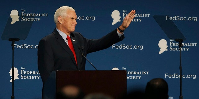Former Vice President Mike Pence waves to attendees at the Florida chapter of the Federalist Society's annual meeting at Disney's Yacht Club resort in Walt Disney World on Friday, Feb. 4, 2022, in Lake Buena Vista, Florida. 