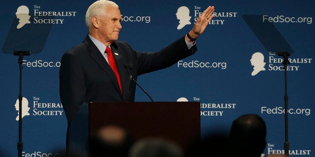 Former Vice President Mike Pence waves to attendees at the Florida chapter of the Federalist Society's annual meeting at Disney's Yacht Club resort in Walt Disney World on Friday, Feb. 4, 2022, in Lake Buena Vista, Florida. 