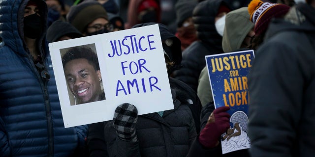 A protester holds a sign demanding justice for Amir Locke at a rally on Feb. 5, 2022, in Minneapolis.
