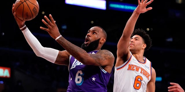 Los Angeles Lakers forward LeBron James shoots as New York Knicks guard Quentin Grimes defends on Feb. 5, 2022, in Los Angeles.