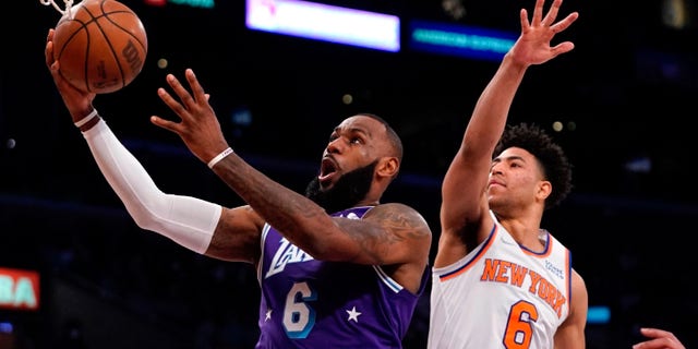 Los Angeles Lakers forward LeBron James shoots as New York Knicks guard Quentin Grimes defends on Feb. 5, 2022, in Los Angeles.