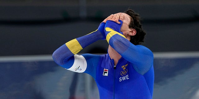 Nils van der Poel of Sweden celebrates after winning the gold medal and setting an Olympic record in the men's speedskating 5,000-meter race at the 2022 Winter Olympics, Sunday, Feb. 6, 2022, in Beijing. 