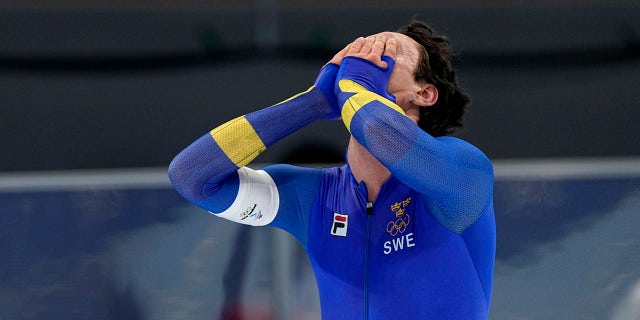 Nils van der Poel of Sweden celebrates after winning the gold medal and setting an Olympic record in the men's speedskating 5,000-meter race at the 2022 Winter Olympics, Sunday, Feb. 6, 2022, in Beijing.