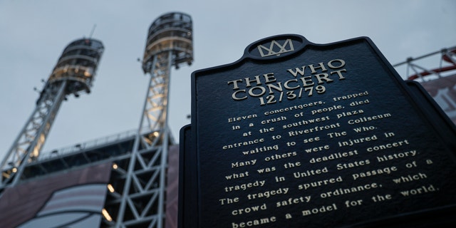 FILE - This Wednesday, Nov. 20, 2019, file photo shows a memorial plaque outside Great American Ball Park in Cincinnati for the 11 concertgoers who were killed in a crush of people entering a 1979 concert at Cincinnati's Riverfront Coliseum by The Who. 