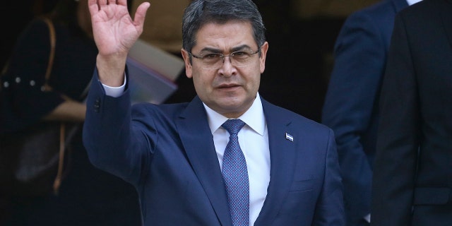 President of Honduras Juan Orlando Hernandez waves as he exits the Academia Diplomatica de Chile where he met with President-elect Sebastian Pinera, in Santiago, Saturday, March 10, 2018. (Associated Press)