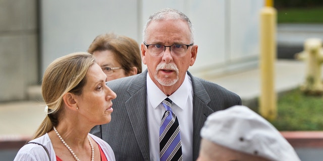 In this June 26, 2019 file photo UCLA gynecologist James Heaps, center, and his wife, Deborah Heaps, arrive at Los Angeles Superior Court. 