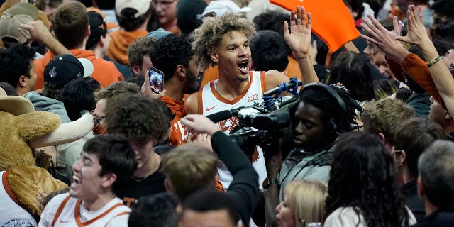 Big 12 fines Texas ,000 for fans storming court 3 Texas forward Tre Mitchell, center, celebrates with fans as they storm the court after Texas' win over Kansas in an NCAA college basketball game, Monday, Feb. 7, 2022, in Austin, Texas.