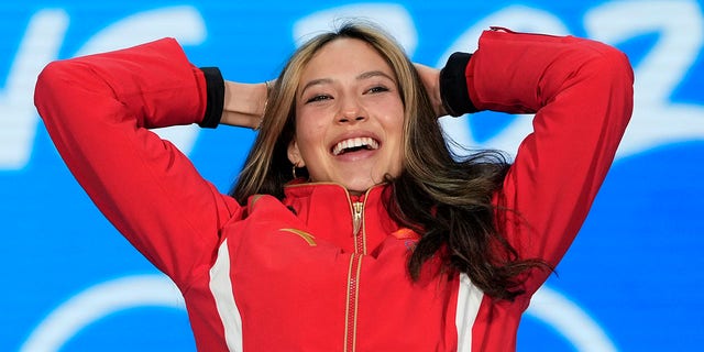 Gold medalist Eileen Gu of China celebrates during the medal ceremony for the women's freestyle skiing big air at the 2022 Winter Olympics, Tuesday, Feb. 8, 2022, in Beijing.