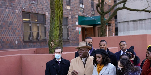 Surrounded by victims of a building fire and their families, attorney Ben Crump, second from left, speaks to reporters at a news conference in the Bronx borough of New York, Tuesday, Feb.  8, 2022. (AP Photo / Seth Wenig)