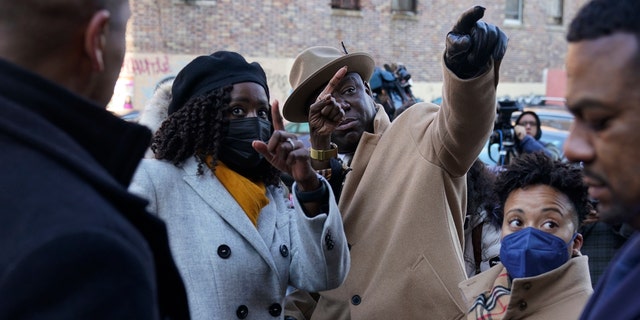 Attorney Ben Crump is shown the apartment building that was the site of a fatal fire last month, after a news conference in the Bronx borough of New York, Tuesday, Feb. 8, 2022. (AP Photo/Seth Wenig)