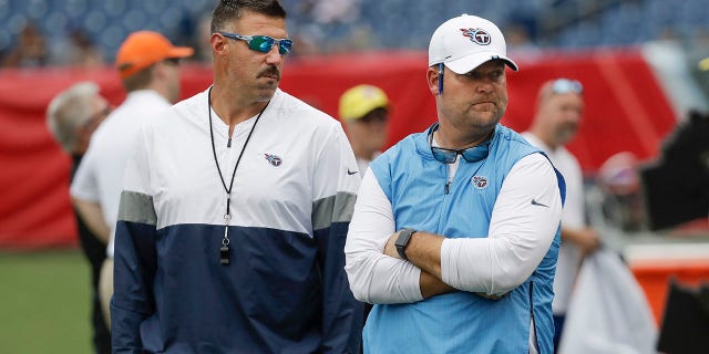 FILE - Tennessee Titans head coach Mike Vrabel, left, and general manager Jon Robinson walk on the field before a practice in Nissan Stadium during NFL football training camp Saturday, Aug. 3, 2019, in Nashville, Tenn. The Tennessee Titans have extended the contracts of general manager Jon Robinson and coach Mike Vrabel to keep them around for years to come, Tuesday, Feb. 8, 2022.