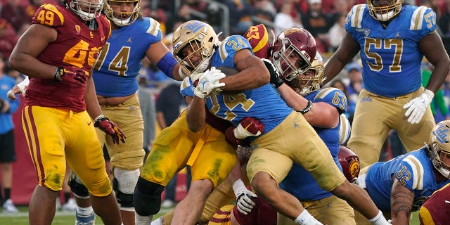 College athlete group files complaint, seeks employee status 3 FILE - UCLA running back Zach Charbonnet (24) runs the ball in for a touch down as Southern California defensive lineman Jacob Lichtenstein (97) tries to stop him during the second half of an NCAA college football game Saturday, Nov. 20, 2021, in Los Angeles. An advocacy group for college athletes has filed a complaint with the National Labor Relations board in the next step in a push to give employee status to college athletes and afford them the right to competitive pay, collective bargaining and other benefits and protections. The National College Players Association on Tuesday, Feb. 8, 2022 filed the unfair labor practice charges against the NCAA, Pac-12 Conference, UCLA and the University of Southern California.