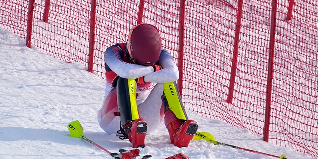 Mikaela Shiffrin of the United States sits on the side of the course after skiing out in the first run of the women's slalom at the 2022 Winter Olympics Feb. 9, 2022, in the Yanqing district of Beijing. 