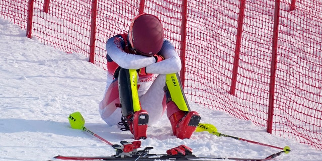 Mikaela Shiffrin of the United States sits on the side of the course after skiing out in the first run of the women's slalom at the 2022 Winter Olympics Feb. 9, 2022, in the Yanqing district of Beijing. 