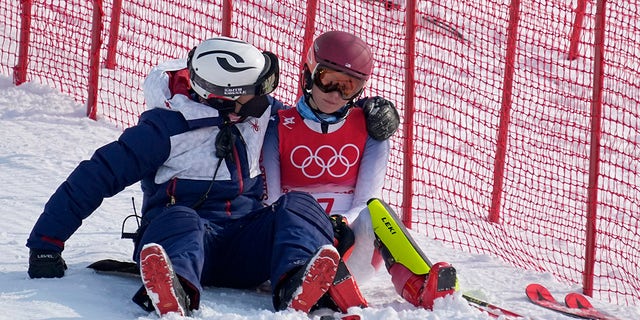 A team member consoles Mikaela Shiffrin, of the United States after she skied out in the first run of the women's slalom at the 2022 Winter Olympics, Wednesday, Feb.  9, 2022, in the Yanqing district of Beijing. 