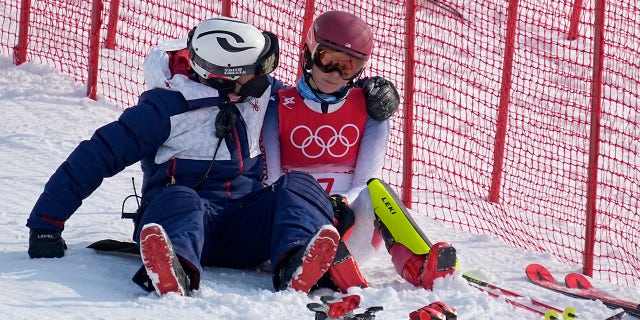 Mikaela Shiffrin's disappointment stirs lessons from Simone Biles: Column 3 A team member consoles Mikaela Shiffrin, of the United States after she skied out in the first run of the women's slalom at the 2022 Winter Olympics, Wednesday, Feb. 9, 2022, in the Yanqing district of Beijing.
