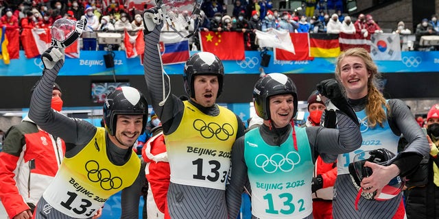 Madeleine Egle, Wolfgang Kindl, Thomas Steu and Lorenz Koller, of the Austria, celebrate winning the silver medal in the luge team relay the 2022 Winter Olympics, Thursday, Feb. 10, 2022, in the Yanqing district of Beijing. 