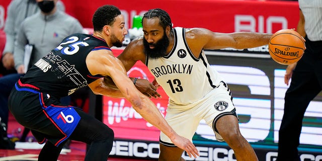 Brooklyn Nets' James Harden (13) tries to drive past Philadelphia 76ers' Ben Simmons (25) during the second half of an NBA basketball game, Saturday, Feb. 6, 2021, in Philadelphia.