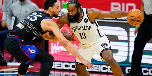 Brooklyn Nets' James Harden (13) tries to drive past Philadelphia 76ers' Ben Simmons (25) during the second half of an NBA basketball game, Saturday, Feb. 6, 2021, in Philadelphia.