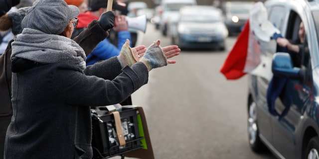 People applaud a convoy departing for Paris, Friday, Feb.11, 2022 in Strasbourg, eastern France.