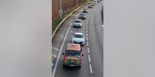 Cars part of a blockade drive on a motorway Friday, Feb.11, 2022 in Lille, northern France.